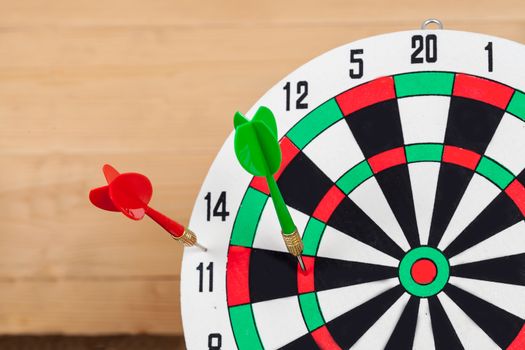 Dart arrow hitting in bullseye on dartboard