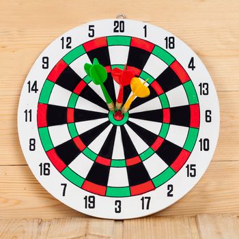 Dart arrow hitting in bullseye on dartboard