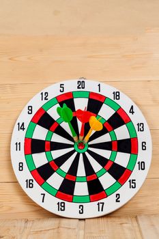 Dart arrow hitting in bullseye on dartboard