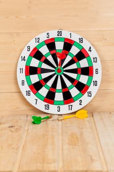 Dart arrow hitting in bullseye on dartboard
