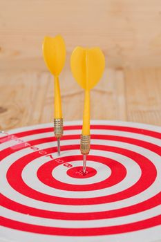 Dart arrow hitting in bullseye on dartboard