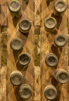wine bottles stacked on wooden racks. Bottom