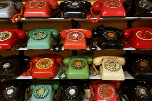 Collection of vintage rotary phone arrange on the shelve