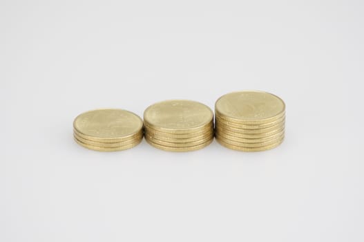 Close up step pile of gold coins isolated place on white background.