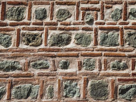 Red thin brick and stone rough pattern wall background.