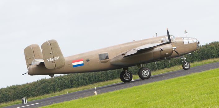 LEEUWARDEN, THE NETHERLANDS - JUNE 10: WW2 B-25 Mitchell bomber in Dutch markings take off during the Dutch Air Force Open House. June 10, 2016 in Gilze-Rijen, The Netherlands