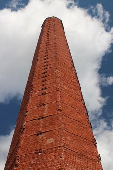 chimney of red brick against a blue sky