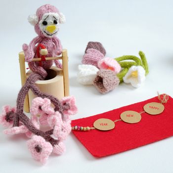 2016, year of monkey, handmade happy new year on white background, knitted monkey, funny stuffed animal, knit flower from yarn, red envelope for lucky money, sign for Vietnam Tet