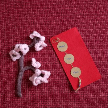 2016, year of monkey, handmade happy new year on red background, knitted monkey, funny stuffed animal, knit flower from yarn, red envelope for lucky money, sign for Vietnam Tet