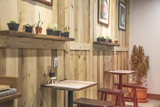 Seat cafe and restaurant interior with wooden furniture and walls.