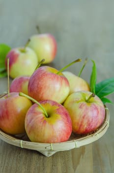 Red and yellow apple  with bamboo basket , organic fresh fruit on white  wooden background