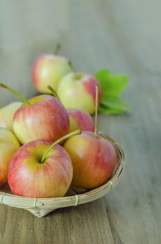 Red and yellow apple  with bamboo basket , organic fresh fruit on white  wooden background