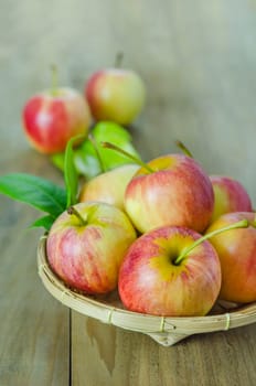 Red and yellow apple  with bamboo basket , organic fresh fruit on white  wooden background