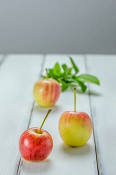 fresh red and yellow apple with leaf on wooden background