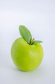 Ripe green apple with leaf  on a white background