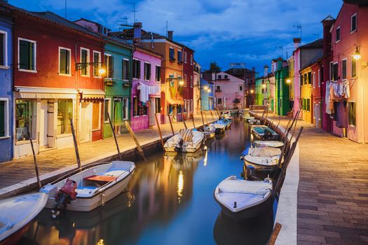 Colourfully painted houses facade on Burano island in evening, province of Venice, Italy