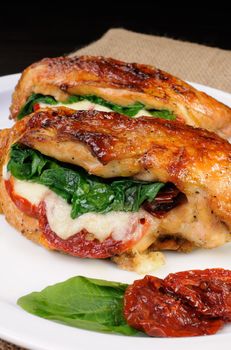 Baked chicken breast stuffed with mozzarella, spinach, sun-dried tomatoes
