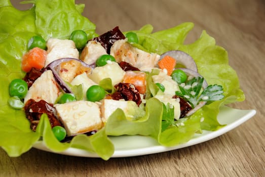 A portion of salad in milk sauce with sesame seeds in lettuce leaves