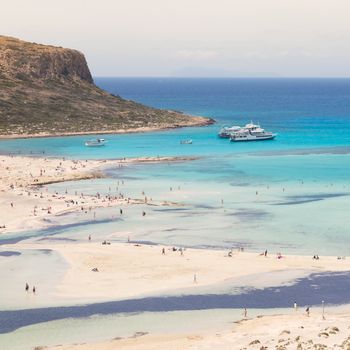 Breathtaking panorama of Balos beach and lagoon and Gramvousa island on Crete, Greece. Tourist boats mooring in lagoon.