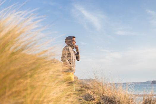 Sporty active man looking at distance, enjoying beautiful nature, freedom and life at serene landscape at Balos beach. Active lifestyle outdoors.