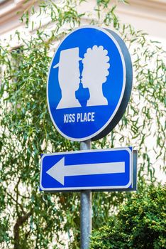 Blue Traffic sign that indicates about the place of kisses in the garden