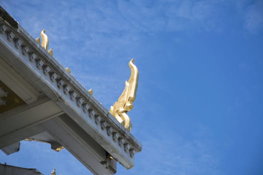 Serpent sculpture of temple roof in Thailand. ornament and detail in Thai art.