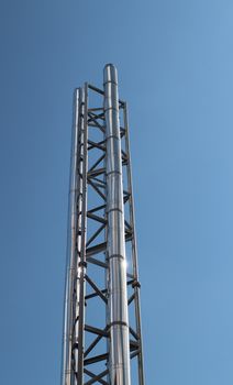 industrial steel chimney against a blue sky