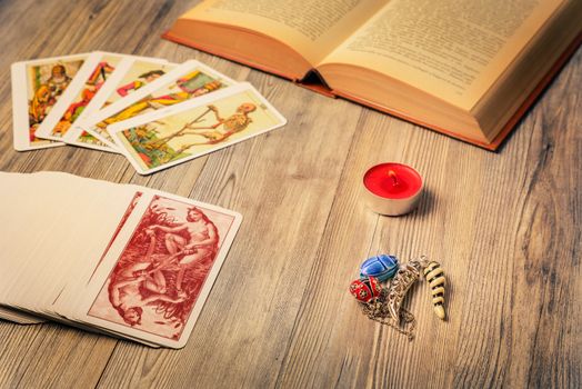 Composition of esoteric objects,candle,Tarots and book used for healing and fortune-telling,vintage style.