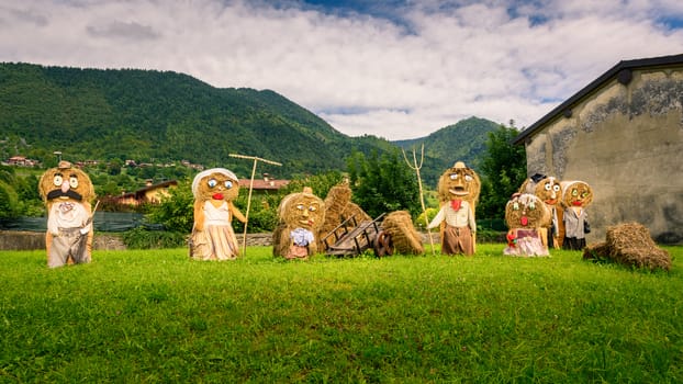 Typical big farmers family, Puppets(straw dolls) made out of Hay Bale with traditional peasant clothes in europe autumn.