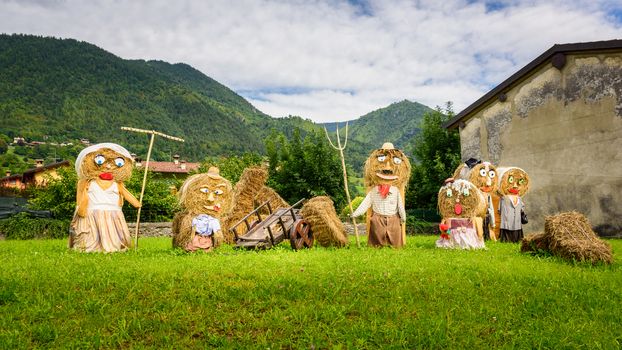 Typical big farmers family, Puppets(straw dolls) made out of Hay Bale with traditional peasant clothes in europe autumn.