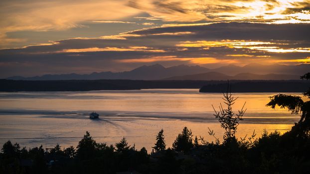 A ferry sails into the sunset in the Puget Sound