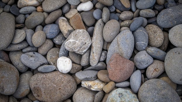 Multicolored pebbles lie on the beach