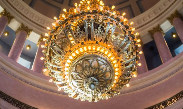 Olympia, WA, USA - 8/21/2014: The 10,000 lb chandelier is part of the largest collection of Tiffany bronze in the world and is suspended 50 ft above the ground by a chain over 100 feet long in the Legislative Building's rotunda.