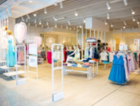 clothes in fashion store, blurred interior of cloth store