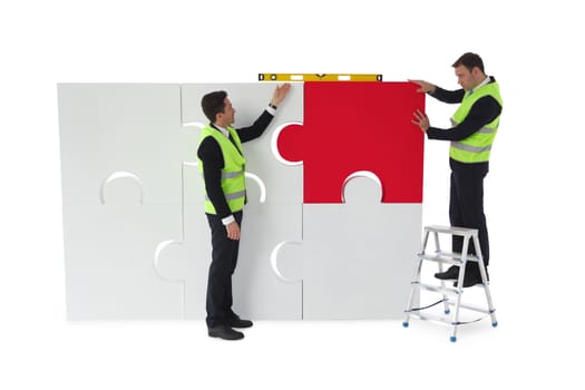 Workers assembling puzzle isolated on white background