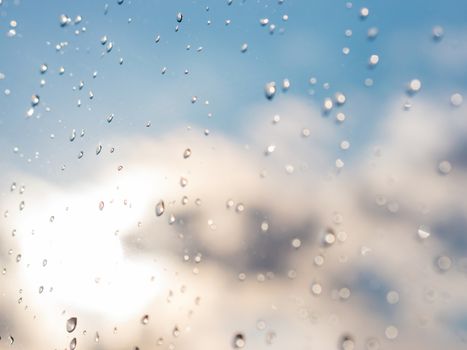 Water drops of rain on blue glass background. Rain drops on window. Shallow DOF.