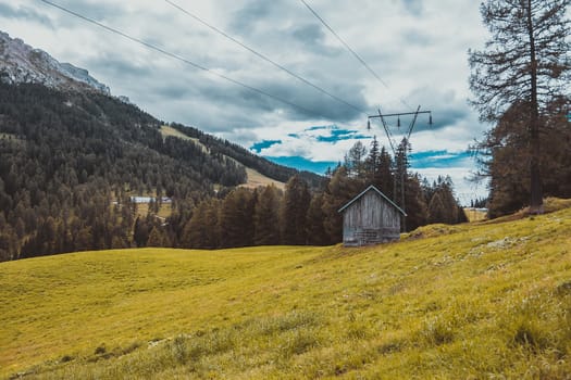 wooden house, landscape in the Alps Italy