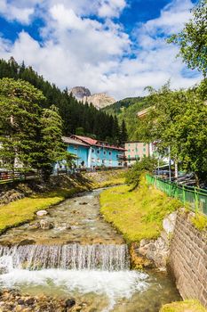 mountain river flowing through village in the Alps