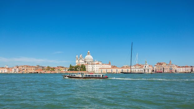 VENICE, ITALY - AUGUST 7 2016: Boat floating from the island of San Giorgio, Venice, Italy