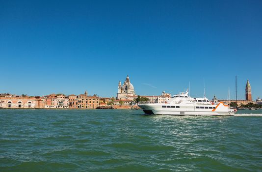 VENICE, ITALY - AUGUST 7 2016: Boat floating from the island of San Giorgio, Venice, Italy