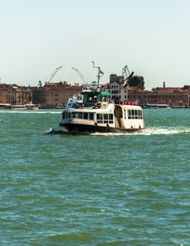 VENICE, ITALY - AUGUST 7 2016: Boat floating from the island of San Giorgio, Venice, Italy