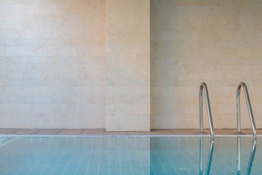 Swimming pool with stair and granite wall - copy space