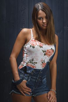 pretty young woman in her twenties wearing demin overalls
