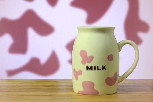 Milk cup on table (Pink cow milk pattern)