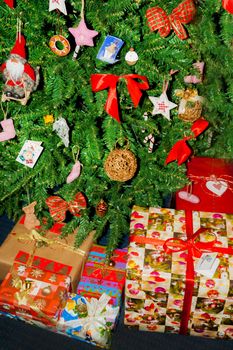 dressed up under the Christmas tree are boxes with gifts.