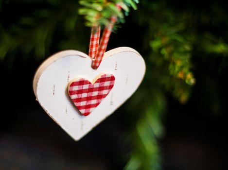 wooden heart tree toy hanging on a tree.