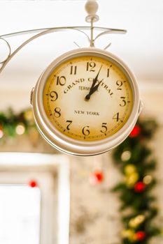 antique clock on the background of Christmas garlands.