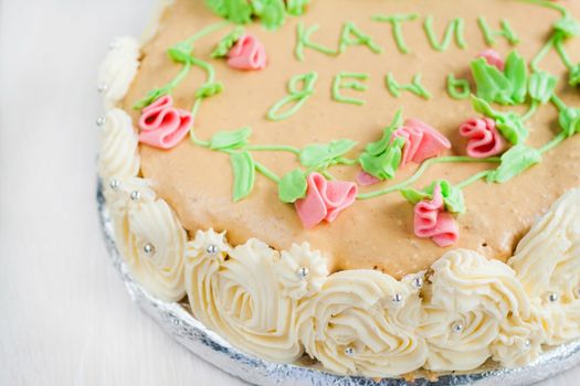 birthday cake decorated with roses, leaves, swirls and the inscription, Catherine Day