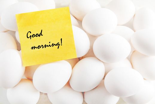 yellow sticker with the inscription on the background of white eggs.