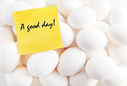 yellow sticker with the inscription on the background of white eggs.